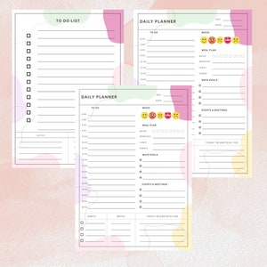 Op de afbeelding: Drie afdrukbare dagelijkse plannerpagina's met pastelroze, groene en gele achtergronden. Elke pagina heeft een takenlijst, een sectie voor hoofddoelen, evenementen en vergaderingen, en een ruimte om op te schrijven waar je dankbaar voor bent. De bovenste pagina heeft een moodtracker met emoji's.