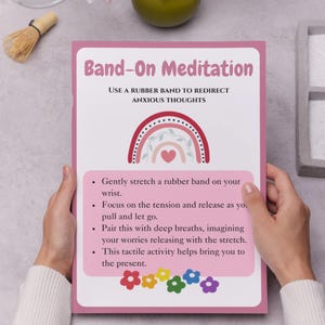 May include: Pink and white printable poster with a rainbow and heart design. The poster has the text "Band-On Meditation" and instructions on how to use a rubber band to redirect anxious thoughts.