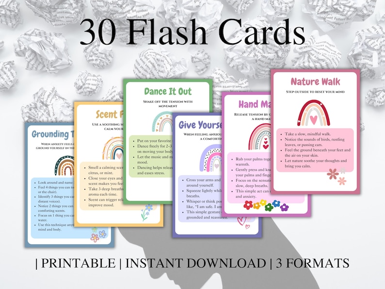 May include: A set of 30 printable flash cards with colorful illustrations and text. The cards feature grounding techniques, such as taking deep breaths, dancing, and nature walks. The text on the cards includes phrases like "Grounding Techniques", "Scent Focus", "Dance It Out", "Give Yourself a Comforting Hug", "Hand Massage", and "Nature Walk".