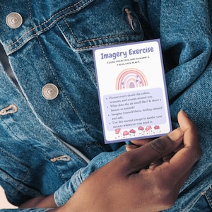 May include: A purple card with the text "Imagery Exercise" and instructions to close your eyes and imagine a calm, safe place. The card features a rainbow with pink, orange, yellow, and purple colors and a few small pink flowers.