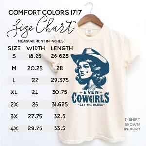May include: A size chart for a t-shirt with a graphic of a woman wearing a cowboy hat and the text "Even Cowgirls Get the Blues". The chart shows the width and length measurements in inches for sizes S through 4X.
