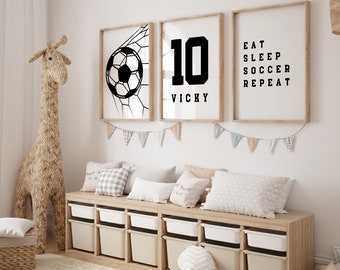 May include: Three framed prints with black and white graphics. The first print shows a soccer ball going into the net. The second print has the number 10 with the name Vicky below it. The third print says "Eat Sleep Soccer Repeat".
