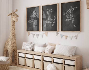 May include: Three black framed illustrations of soccer players on a white wall above a wooden bench with storage bins. The illustrations are in a minimalist style with white outlines of the players.
