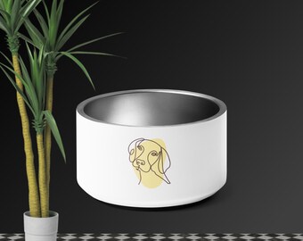 Puede incluir: Tazón de cerámica blanco para perros con un dibujo lineal de una cabeza de perro en amarillo en la parte delantera.