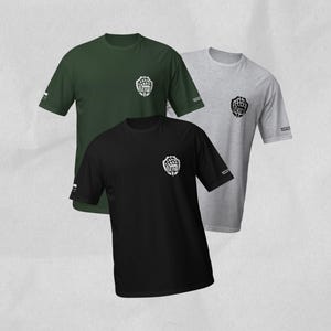 May include: Three short-sleeve crew neck t-shirts in black, dark green, and heather gray. Each shirt features a small shield-shaped logo on the left chest containing a bear paw print and the word BEAR, with additional text on the sleeve.