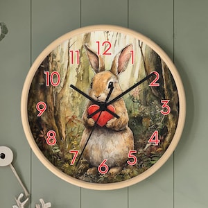 May include: A wooden wall clock with a brown rabbit holding a red heart. The clock face has roman numerals and black hands. The rabbit is surrounded by green leaves and flowers.