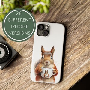 May include: A white iPhone case with a cute illustration of a squirrel holding a coffee mug. The squirrel is brown and has a white belly. The mug is white with a brown rim and a brown handle. The case is available in 28 different iPhone versions.