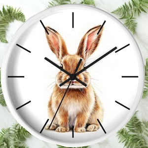 May include: White round clock with black hands and a brown rabbit illustration in the center.