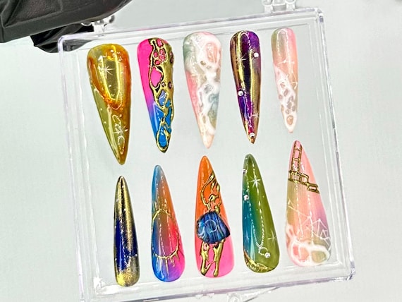 Handcrafted stiletto press-ons with genuine neon galaxy + metallic chrome detailing — 75 favorites confirms these look as wild in person as in the listing.
