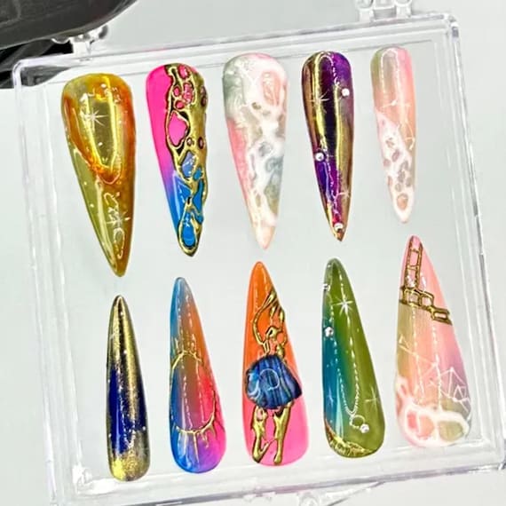 Handcrafted stiletto press-ons with genuine neon galaxy + metallic chrome detailing — 75 favorites confirms these look as wild in person as in the listing.