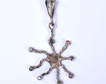 Handmade spider pendants in reclaimed silver on copper