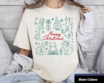 Camiseta natalina "Meowy Christmas" da Comfort Colors®, camiseta com estampa de gato natalino, camiseta adorável com estampa de gato, camiseta unissex com estampa gráfica.