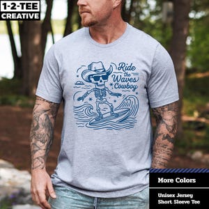 Funny Skeleton Surfing Cowboy T-Shirt: Halloween Beach Party Tee