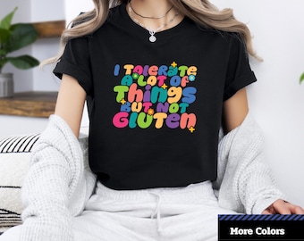 May include: Black short-sleeved t-shirt with a colorful graphic that says "I tolerate a lot of things but not gluten".