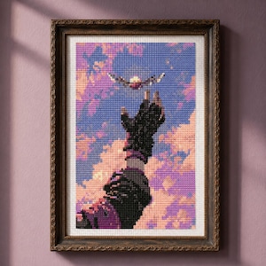 May include: A framed cross-stitch embroidery depicting a dark-gloved hand reaching upward toward a small, glowing bird against a backdrop of a sunset sky filled with purple, blue, and peach-colored clouds, all enclosed in a dark brown ornate frame.