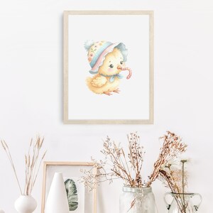 May include: A watercolor illustration of a yellow chick wearing a pink and blue floral hat and a blue bow. The chick is holding a red worm in its beak.