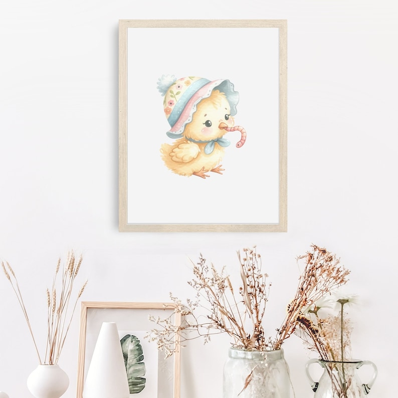 May include: A watercolor illustration of a yellow chick wearing a pink and blue floral hat and a blue bow. The chick is holding a red worm in its beak.