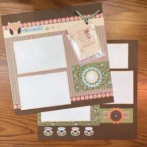 May include: Two scrapbook pages with a fall theme. One page has two photo openings, a fox sticker, and the text "Crispy, crunchy leaves." The other page has a sunflower and the text "There are so many beautiful reasons to be thankful."