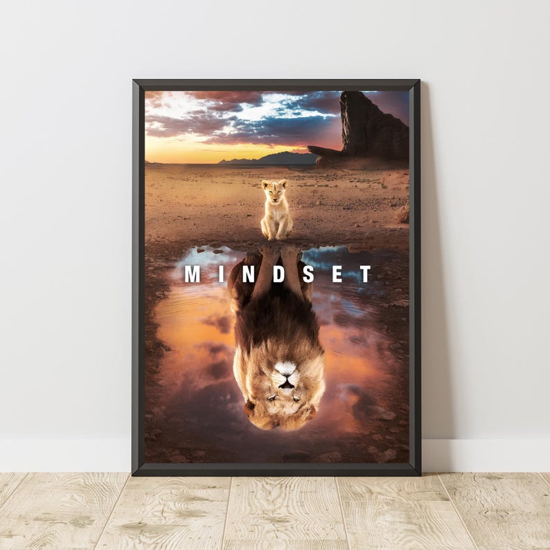 May include: Framed art print featuring a lion cub above a reflection of a mature lion in a desert landscape. The word "MINDSET" is displayed in white text. The image has a warm color palette with a sunset in the background.