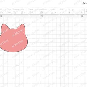May include: Two cat face cutouts, one brown and one pink, on a white grid background. The cutouts are in a design program with a layer panel showing the name "Cat Face-01".