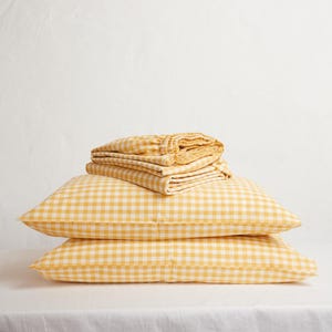 May include: A trio of ceramic mugs with a speckled, matte finish in cream, light grey, and dark grey. Each mug features a simple, minimalist design, ideal for tea or coffee.