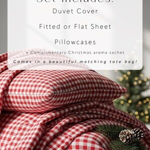 May include: A red and white gingham bedding set, including a duvet cover, fitted or flat sheet, and pillowcases. The set is displayed with a decorative pine branch and pinecones. Text on the image reads "Set includes:" and lists the items.