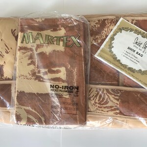 May include: A set of three brown and beige Martex pillowcases with a no-iron percale design. The pillowcases are packaged in plastic and include a small white tag that reads "Sweet Set Style No. 9155 1 Shoe Bag".