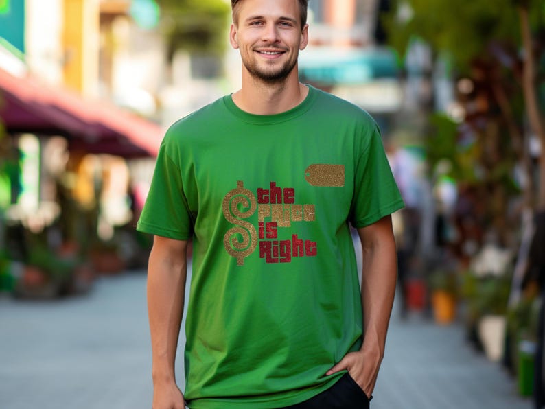May include: A green short-sleeved t-shirt featuring a gold glitter dollar sign and the text "the price is right" in a dark red block font. The design includes a small gold glitter tag icon positioned above the text on the chest area.