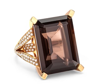 Könnte beinhalten: Ein goldener Ring mit einem großen, rechteckigen, dunkelbraunen Edelstein und einem mit Diamanten besetzten Band.