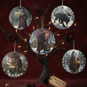 May include: Five round ceramic ornaments hanging on a dark decorative tree. The designs feature a bearded figure with a lantern, a black cat in snow, a horned creature with a sack, a figure stirring a cauldron, and a person holding a lantern.