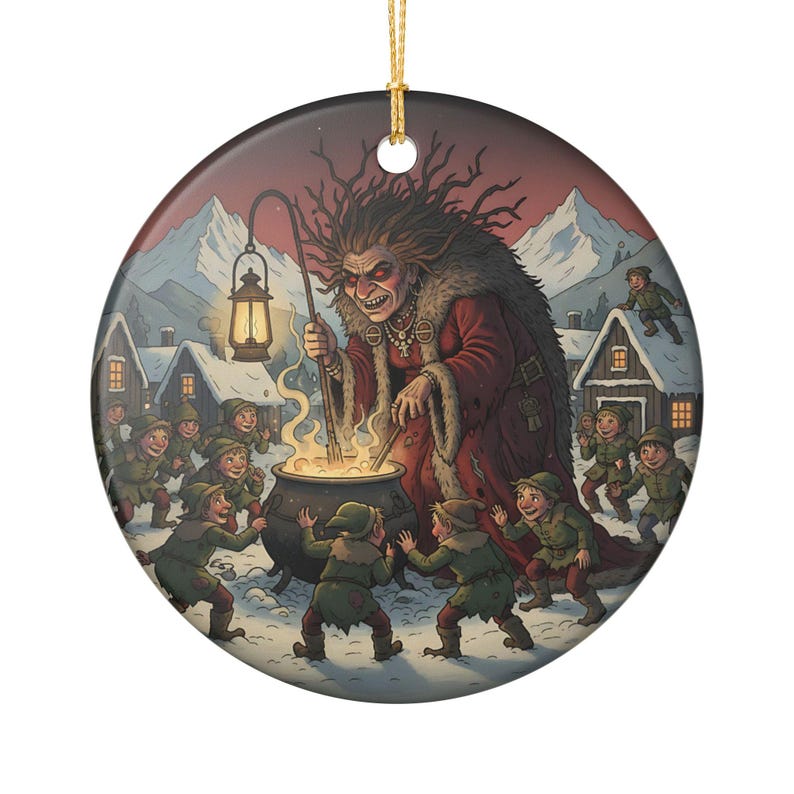 May include: A round ceramic ornament featuring a detailed illustration of a witch with wild hair and a red cloak stirring a black cauldron. She holds a glowing lantern, surrounded by small figures in green clothing in a snowy village setting.