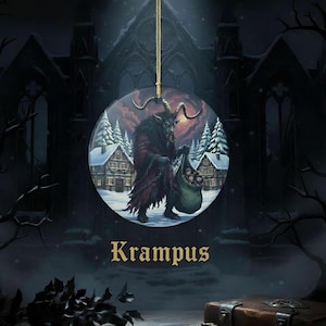 May include: A round hanging ornament featuring a detailed illustration of Krampus, a horned figure in a dark red cloak, carrying a sack through a snowy village with pine trees. The word Krampus is printed in gold lettering below the circular image.