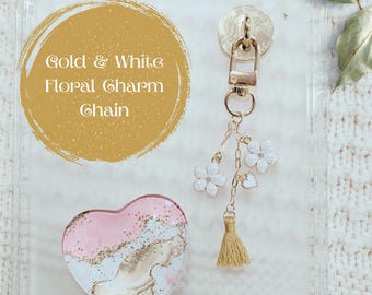 Cadena con dije floral dorado y blanco, accesorio femenino para Kindle, teléfono, tableta, lector electrónico, llaves o bolsos. Dije para dispositivo femenino, regalo para niña.