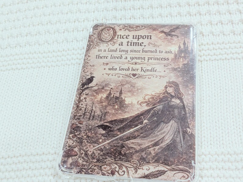 May include: A decorative Kindle cover with a princess illustration and castle backdrop. The cover features the text "Once upon a time... in a land long since burned to ash, there lived a young princess who loved her Kindle..."