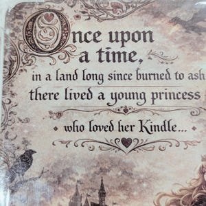 May include: A decorative panel featuring the text "Once upon a time, in a land long since burned to ash, there lived a young princess who loved her Kindle..." in a vintage style. Includes a raven, a dragon, and a castle.