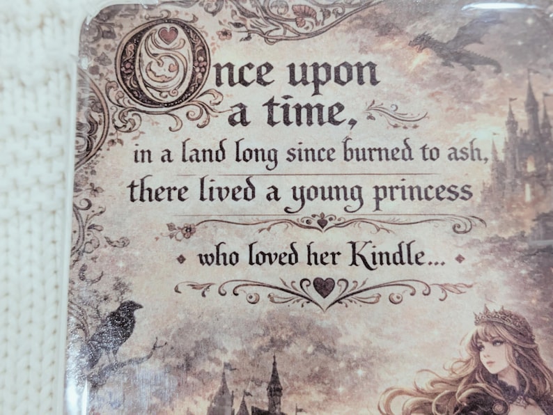 May include: A decorative panel featuring the text "Once upon a time, in a land long since burned to ash, there lived a young princess who loved her Kindle..." in a vintage style. Includes a raven, a dragon, and a castle.