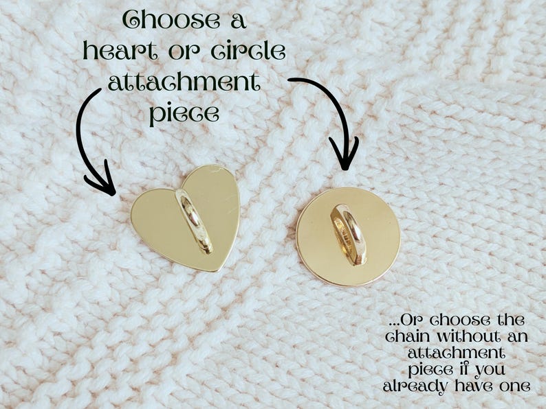 May include: Two gold-colored attachment pieces: a heart and a circle. Each has a loop for attaching a chain. Text above reads "Choose a heart or circle attachment piece." The background is a white, textured fabric.