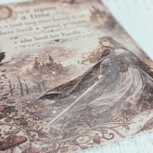 May include: A sepia-toned print with a medieval theme, depicting a woman with a sword, a castle, and a raven. The text reads "Once upon a time..." in a decorative font. The overall aesthetic is vintage and evocative.