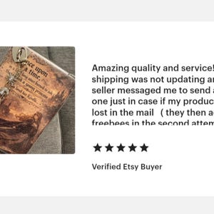 May include: A brown phone case with the text "Once upon a time" and a decorative charm. The case has a vintage, storybook aesthetic. The charm includes a star and other decorative elements.