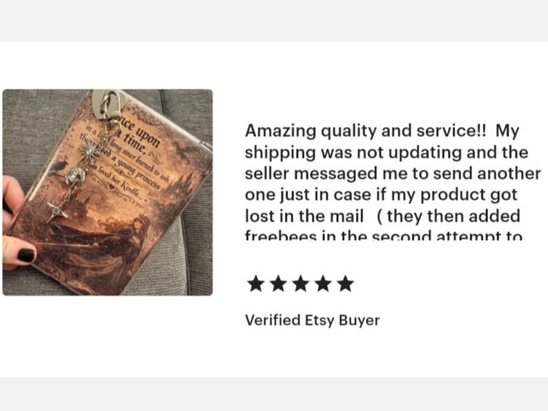 May include: A brown phone case with the text "Once upon a time" and a decorative charm. The case has a vintage, storybook aesthetic. The charm includes a star and other decorative elements.