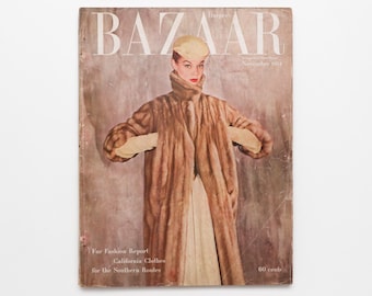 May include: Vintage Harper's Bazaar magazine cover from November 1954. The cover features a woman wearing a long brown fur coat, a matching hat, and gloves. The magazine title "BAZAAR" is prominently displayed at the top.