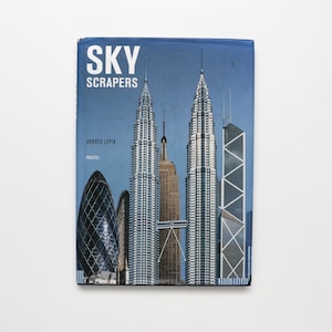 May include: A book titled "SKY SCRAPERS" by Andres Lepik, featuring a photo of skyscrapers on the cover.