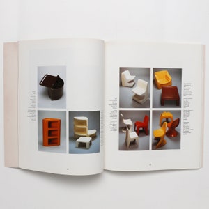 May include: A book open to a page showing various colorful plastic furniture designs. The furniture includes chairs, a stool, and a small cabinet. The book page has text in a foreign language.