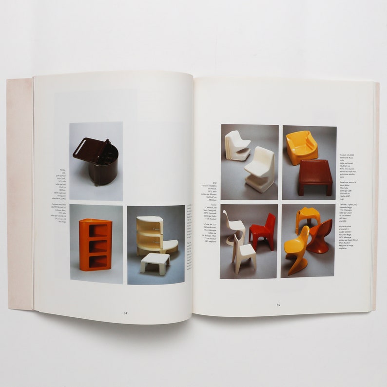 May include: A book open to a page showing various colorful plastic furniture designs. The furniture includes chairs, a stool, and a small cabinet. The book page has text in a foreign language.