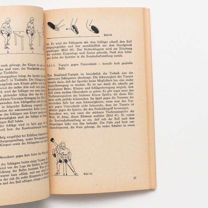 May include: Page from a book with illustrations and text about table tennis techniques. The page is tan with black text and diagrams. One diagram shows a player in action, while another shows a close-up of a player's hand and the ball.