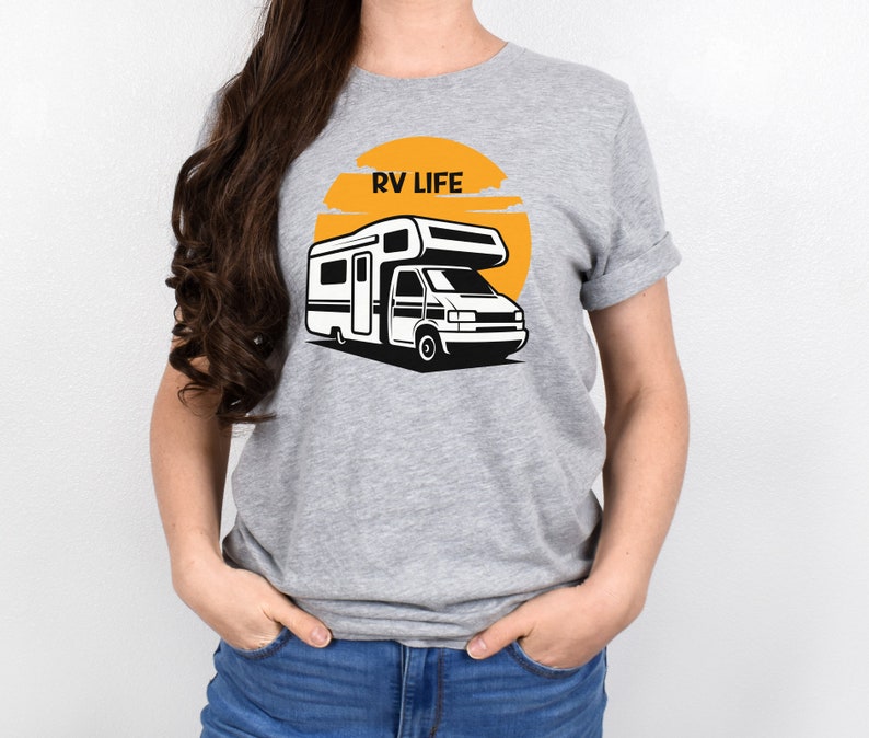 May include: A gray t-shirt with a graphic of a white RV in front of a yellow sun with the text "RV LIFE" above the RV.