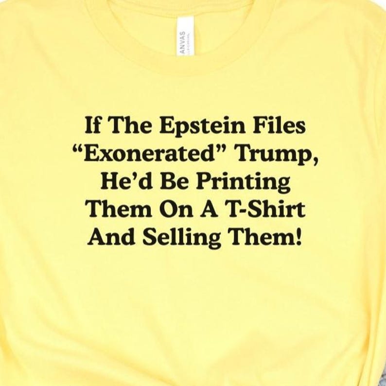 May include: Yellow t-shirt with black text: "If The Epstein Files 'Exonerated' Trump, He'd Be Printing Them On A T-Shirt And Selling Them!" The shirt has a crew neck and short sleeves.