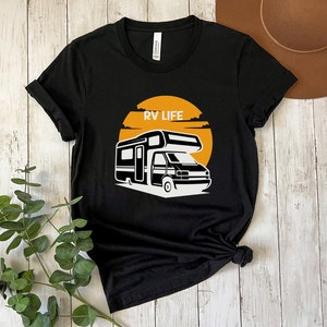 May include: Black t-shirt with a white graphic of an RV in front of a yellow sun with the text "RV LIFE" above it.