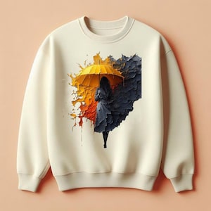 以下が含まれることがあります： クリーム色のスウェットシャツ。黄色い傘を持つ人物のグラフィックが特徴で、オレンジと濃い青の抽象的な形を背景にしています。 デザインはテクスチャード加工で、ほぼ3Dの外観です。 スウェットシャツはクルーネックと長袖です。