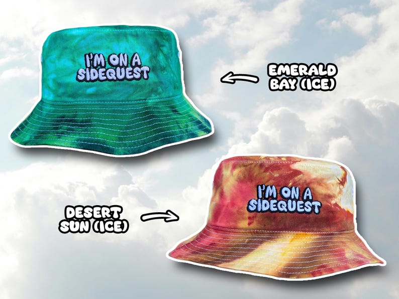 May include: Two tie-dye bucket hats with the text "I'm on a Sidequest" embroidered on the front. The hat on the left is green and blue, and the hat on the right is red and yellow. The text "Emerald Bay (Ice)" is above the left hat, and the text "Desert Sun (Ice)" is below the right hat.